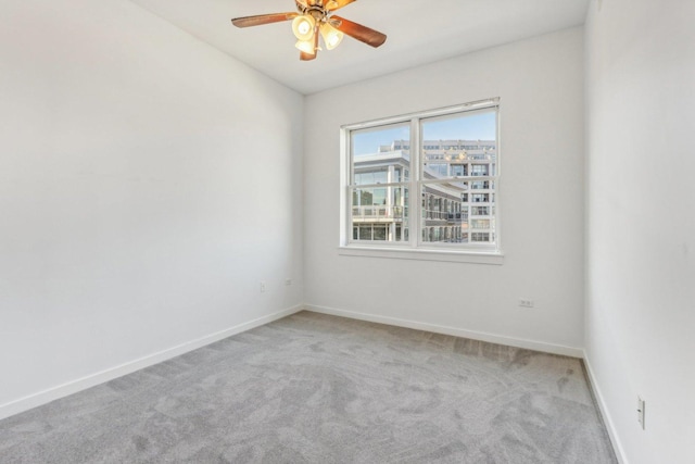 empty room featuring light colored carpet and ceiling fan