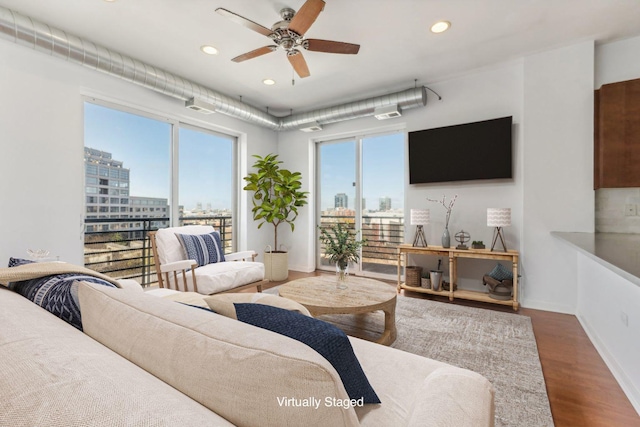 living room featuring ceiling fan and hardwood / wood-style floors