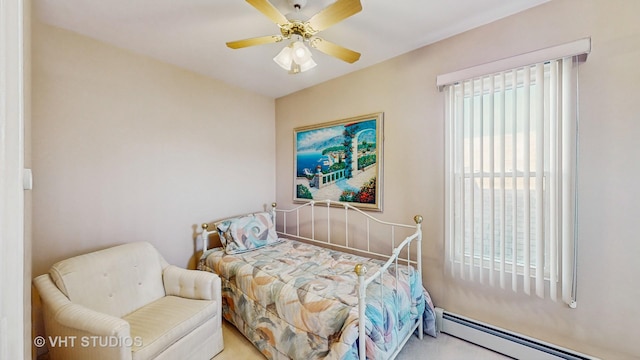 bedroom with a baseboard heating unit and ceiling fan