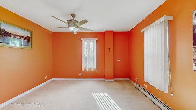 empty room featuring ceiling fan, light colored carpet, and baseboard heating