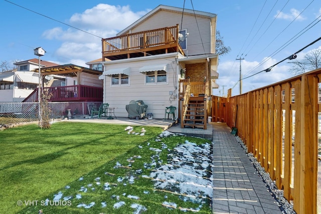 rear view of property with a balcony, a yard, and a patio area