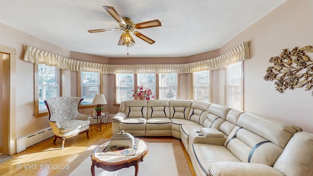 living room featuring ceiling fan, a baseboard radiator, and light hardwood / wood-style flooring