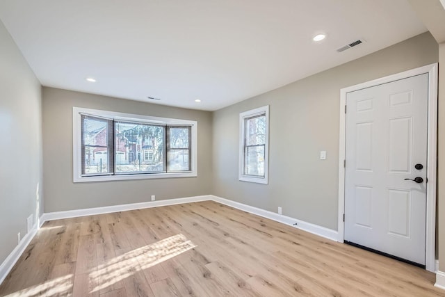 spare room featuring light hardwood / wood-style floors