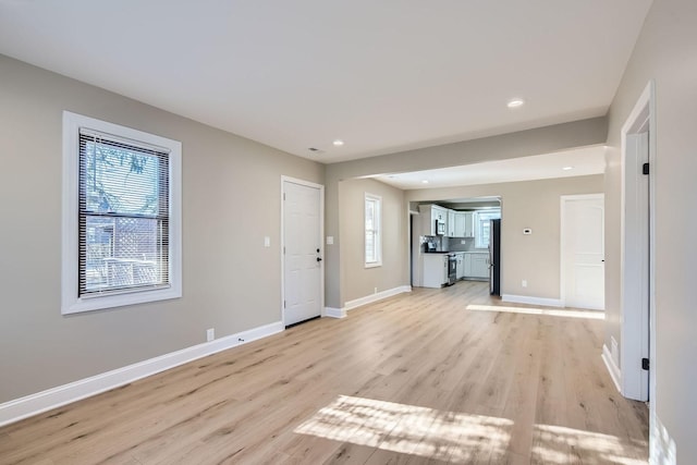 entryway with plenty of natural light and light hardwood / wood-style floors