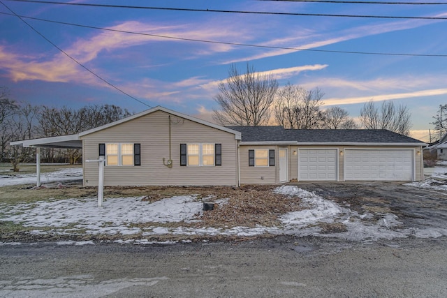 view of front of home featuring a garage and a carport