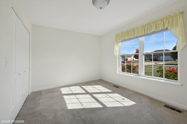 unfurnished bedroom with carpet floors and a closet