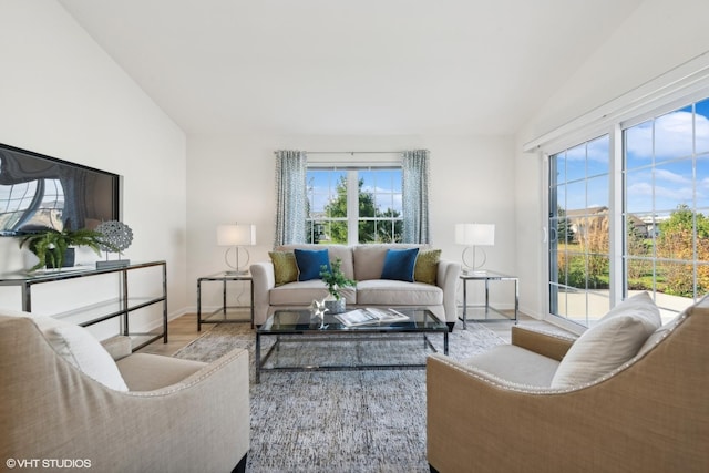 living room with vaulted ceiling and light hardwood / wood-style floors