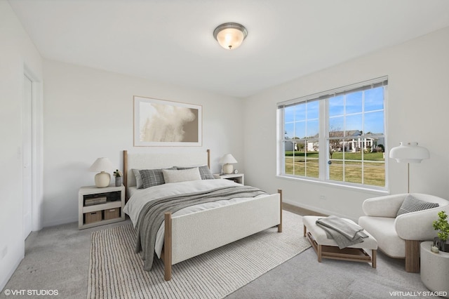 bedroom featuring light carpet