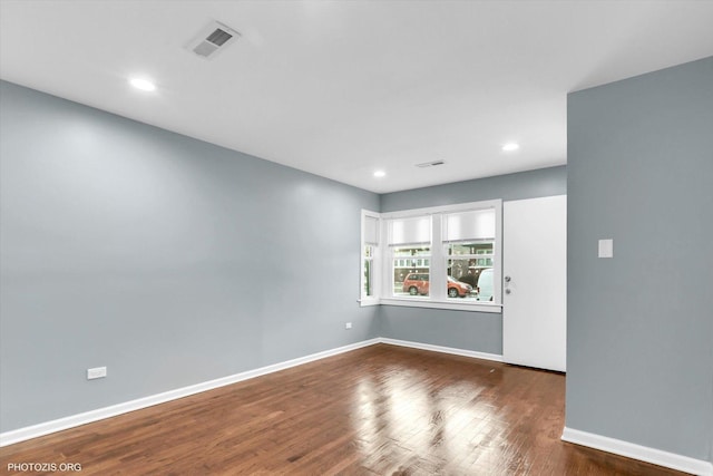 empty room featuring dark hardwood / wood-style flooring