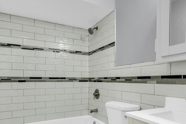 full bathroom with vanity, tiled shower / bath combo, and toilet