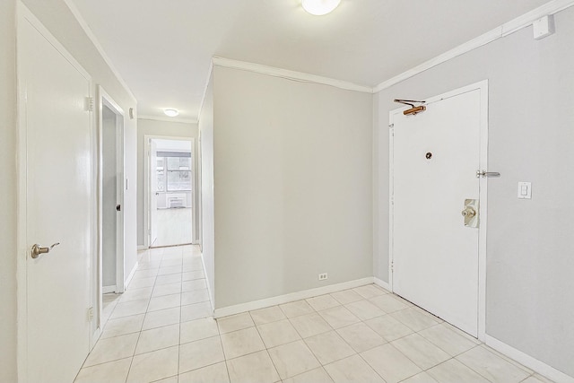 entryway featuring light tile patterned flooring and ornamental molding