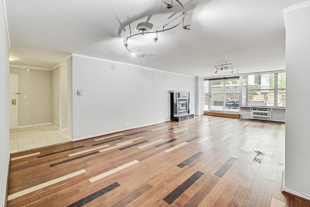 unfurnished living room with ornamental molding and light hardwood / wood-style flooring