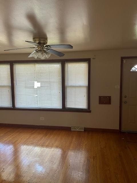 foyer entrance with hardwood / wood-style floors and ceiling fan