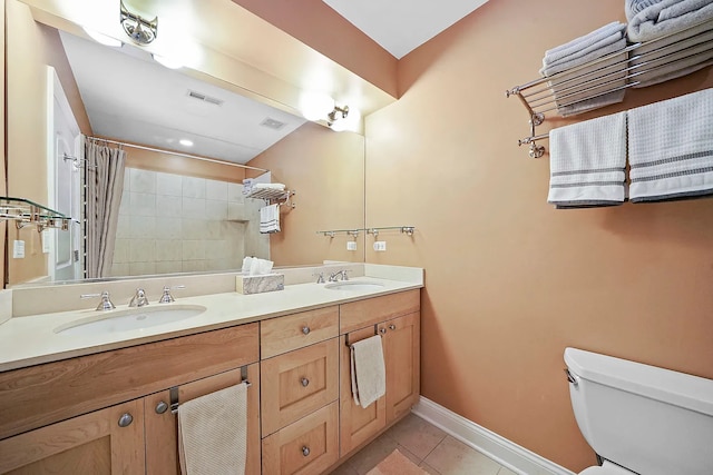 bathroom with tile patterned flooring, vanity, a shower with curtain, and toilet