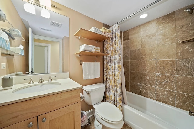 full bathroom with shower / tub combo with curtain, vanity, and toilet