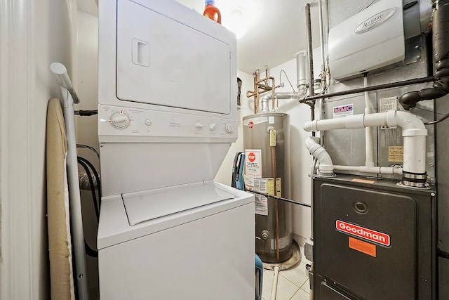 washroom featuring stacked washer / dryer, heating unit, light tile patterned floors, and water heater