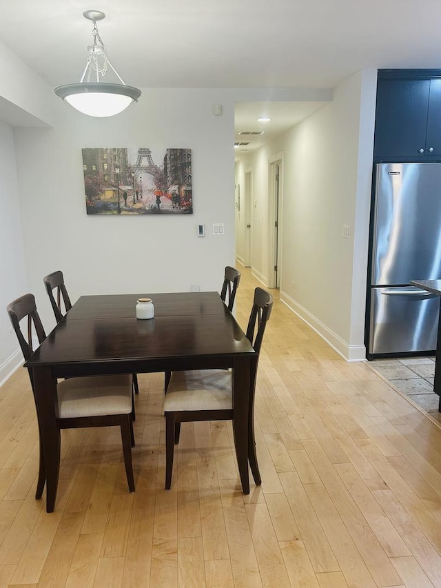 dining space with light hardwood / wood-style flooring