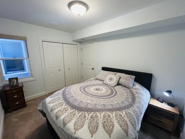 bedroom featuring dark carpet and a closet