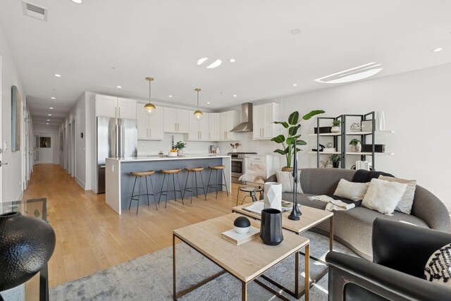 living room with sink and light wood-type flooring