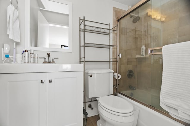 full bathroom featuring vanity, toilet, and combined bath / shower with glass door