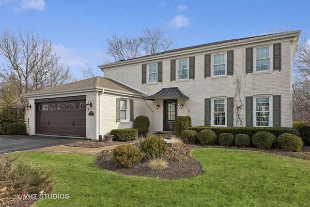 view of front of property with a garage and a front yard