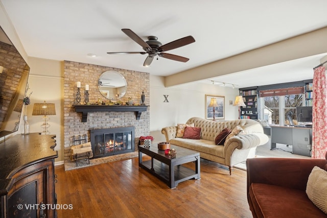 living room with hardwood / wood-style floors, a fireplace, and ceiling fan