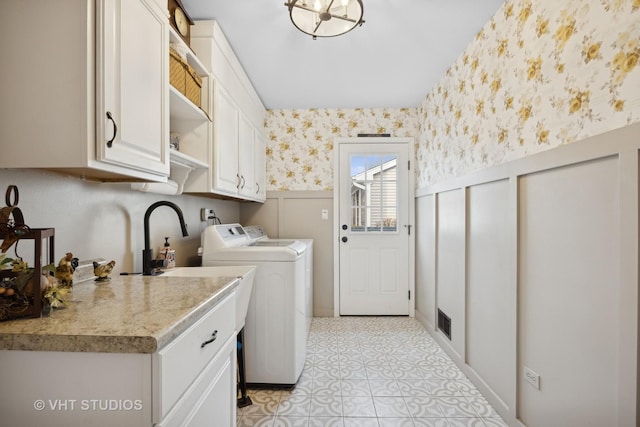 washroom with cabinets and separate washer and dryer