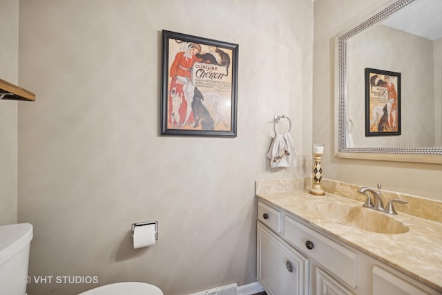 bathroom featuring vanity and toilet