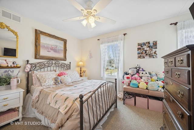 carpeted bedroom with multiple windows and ceiling fan