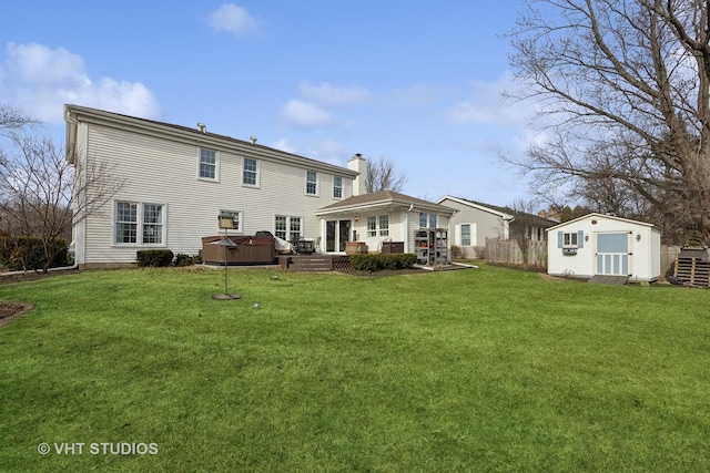 rear view of property featuring a yard, a patio area, a hot tub, and a storage unit