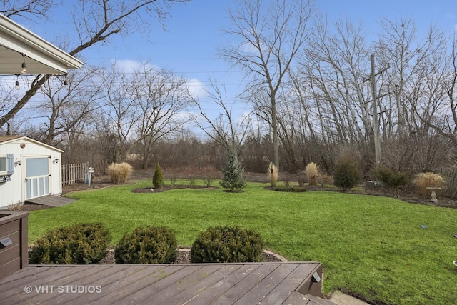 view of yard featuring a storage shed and a deck