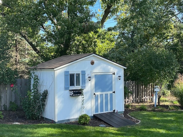 view of outbuilding with a lawn