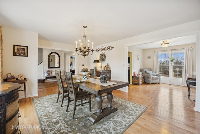 dining area featuring a chandelier and light wood-type flooring