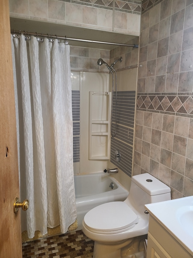 full bathroom with shower / bath combo with shower curtain, vanity, toilet, and tile walls