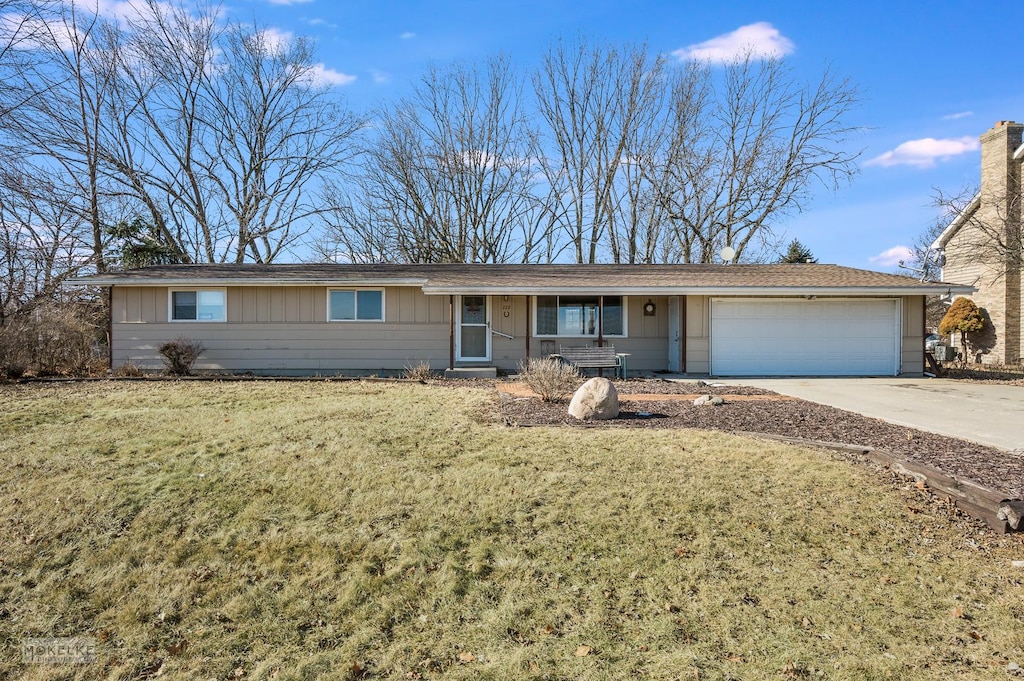 ranch-style home with a garage and a front yard