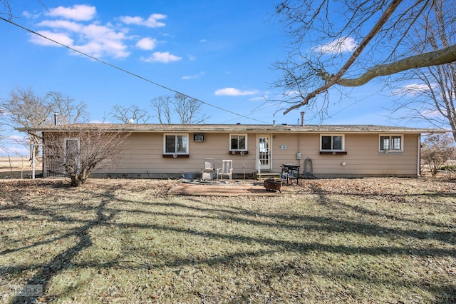 back of property featuring a lawn