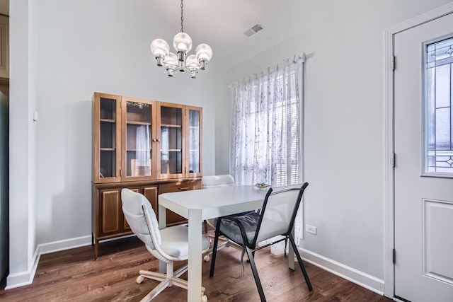 dining space featuring a chandelier and dark hardwood / wood-style flooring