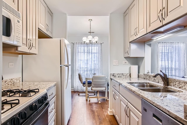 kitchen with sink, white cabinets, hanging light fixtures, and dishwasher