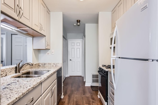 kitchen featuring dark hardwood / wood-style flooring, sink, white appliances, and light stone countertops