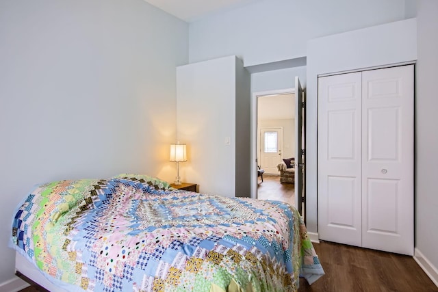 bedroom featuring dark hardwood / wood-style floors and a closet