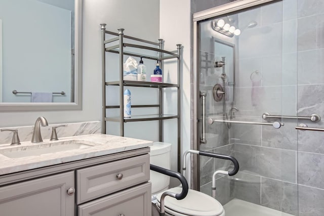 bathroom featuring walk in shower, vanity, and toilet