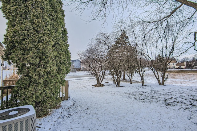 snowy yard with central AC unit