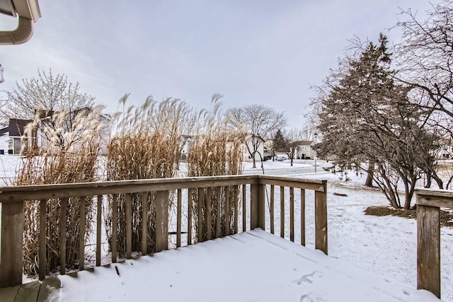 yard layered in snow with a deck