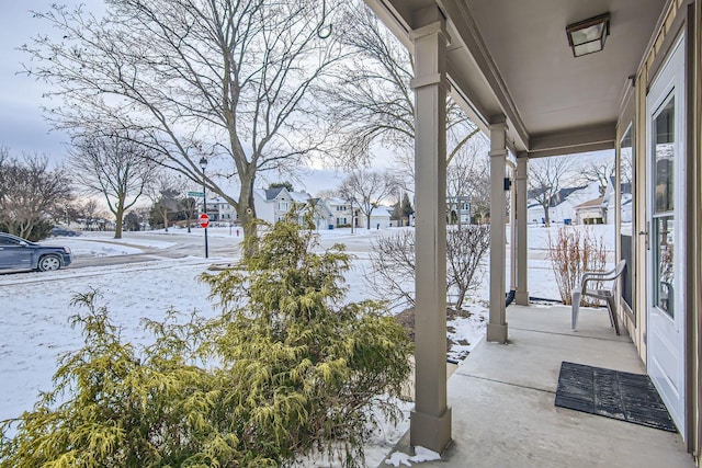 snowy yard with a porch