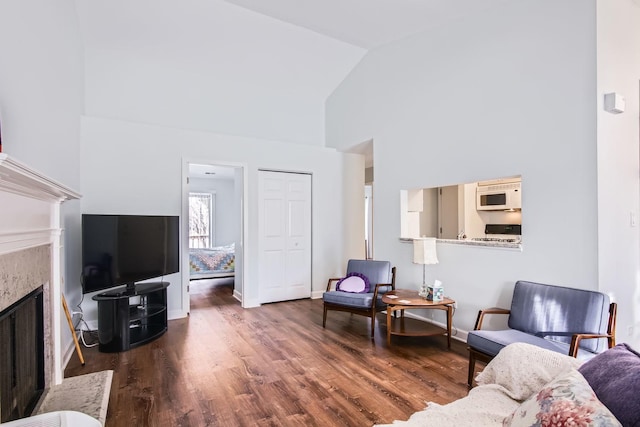 living room featuring dark wood-type flooring and high vaulted ceiling