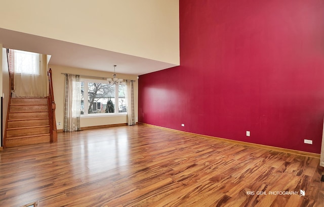 interior space featuring hardwood / wood-style flooring and an inviting chandelier