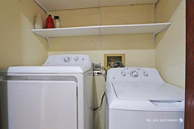 clothes washing area with washing machine and dryer