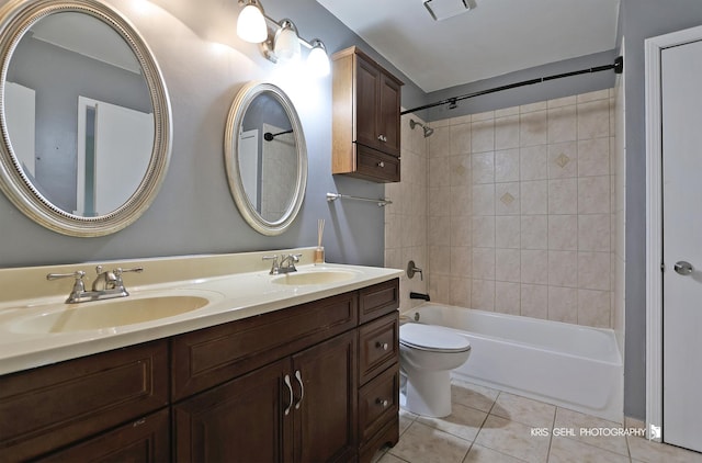 full bathroom featuring tile patterned flooring, vanity, toilet, and tiled shower / bath