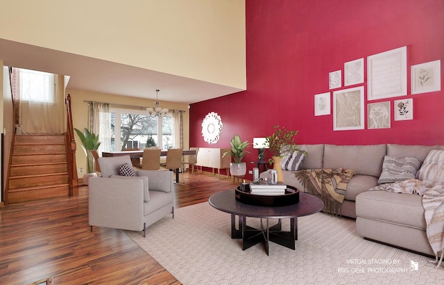 living room with hardwood / wood-style floors and a notable chandelier