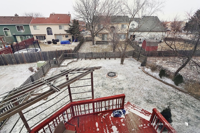 snow covered patio featuring an outdoor fire pit